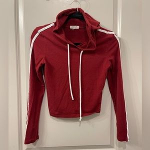 Dark red jersey knit cropped hooded shirt with one white stripe down each arm
